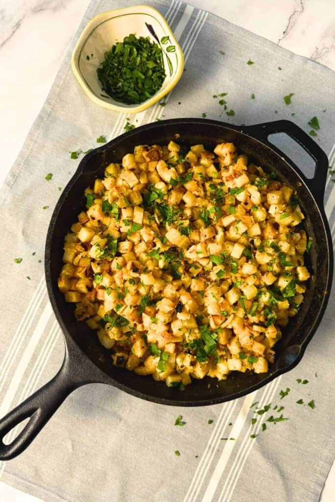 Cast iron pan full of crispy breakfast potatoes