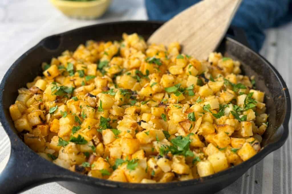 Cast iron pan full of crispy breakfast potatoes