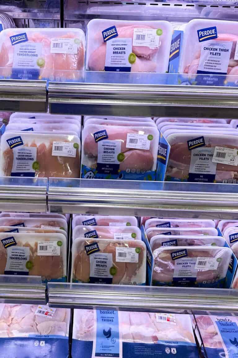 Supermarket shelf showing various packages of chicken breast