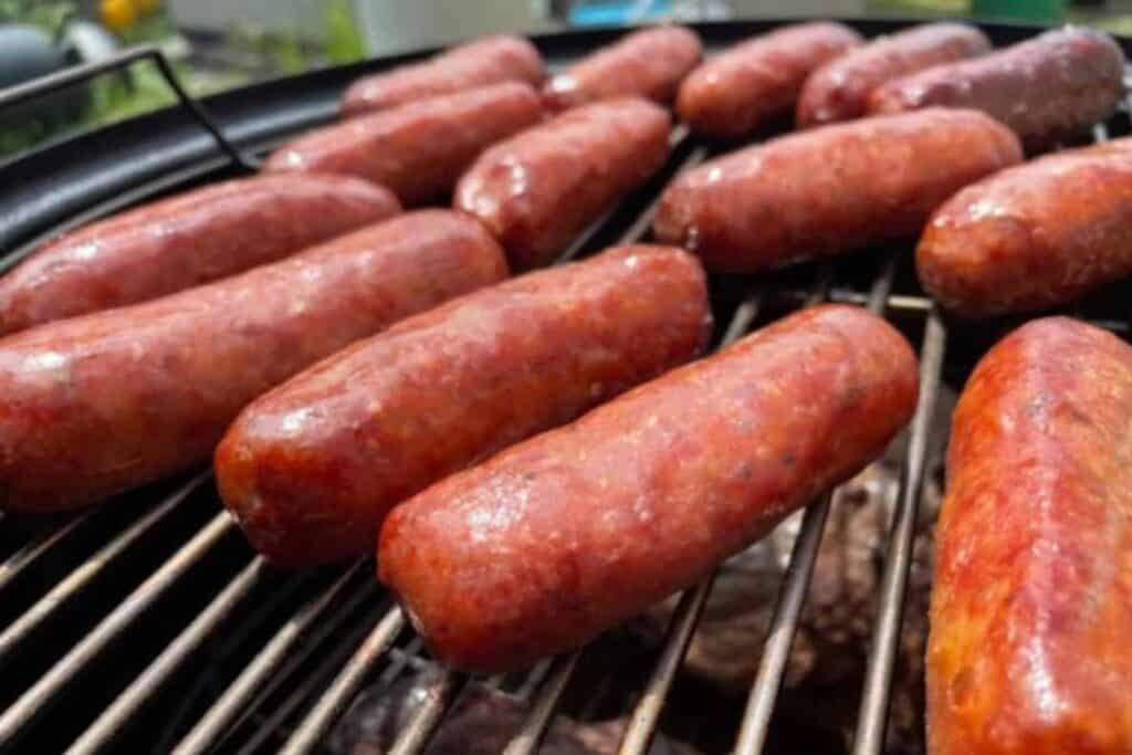 Italian sausage smoking on a grill