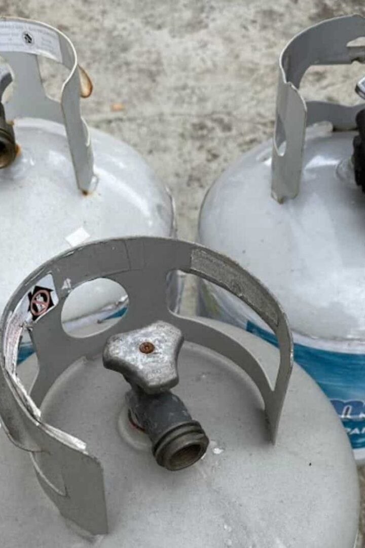 Three propane tanks sitting on a patio