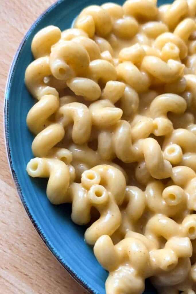 Creamy homemade mac and cheese on a blue plate