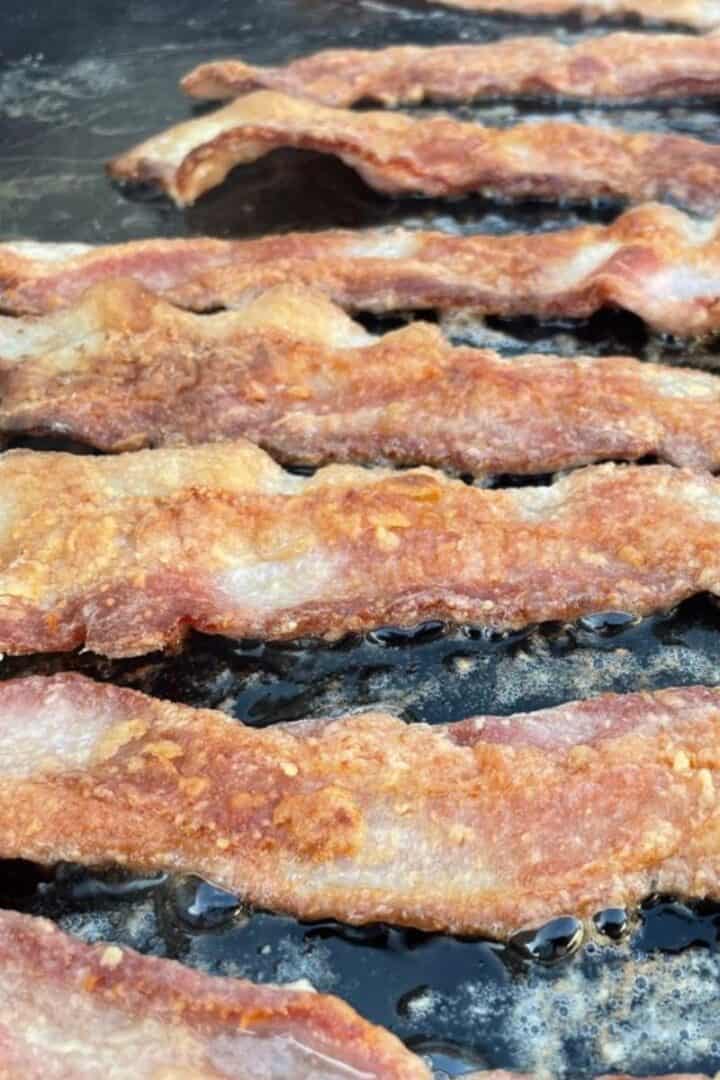 Bacon cooking on a Blackstone griddle