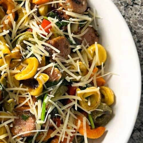 Blackstone tortellini and sausage on a white plate