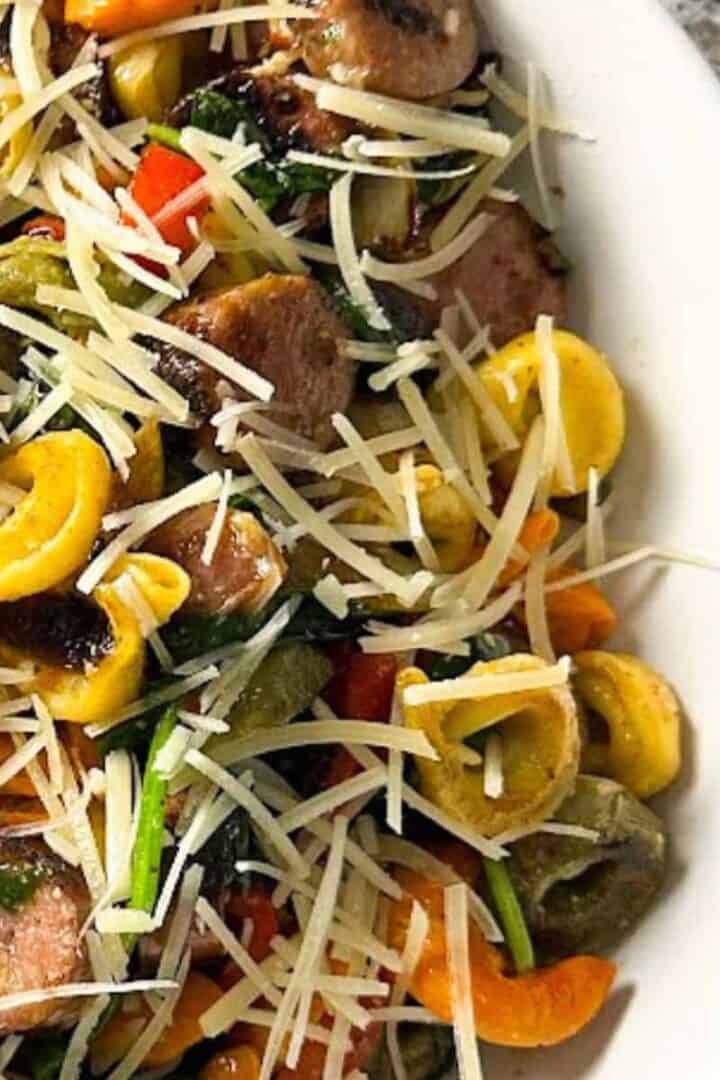 Blackstone tortellini and sausage on a white plate