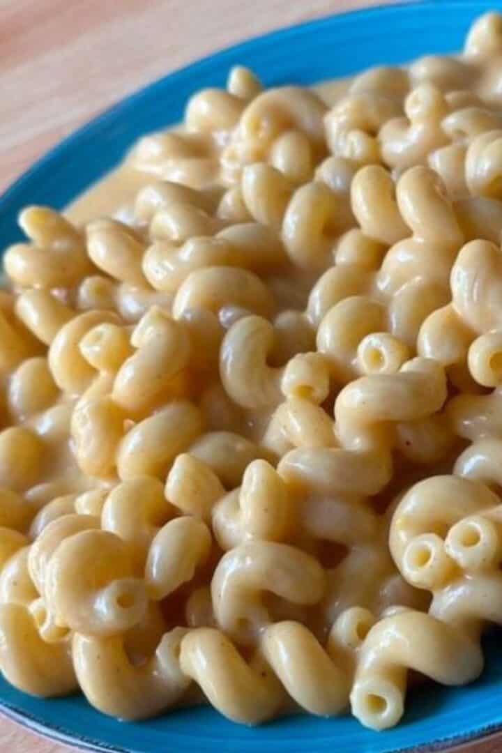 A blue plate of homemade creamy stovetop mac and cheese