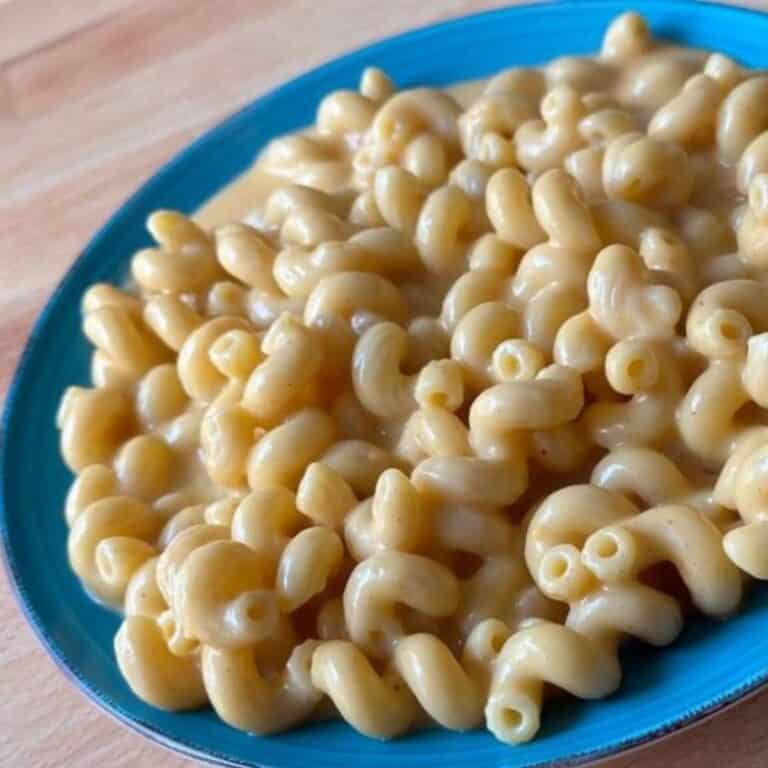 A blue plate of homemade creamy stovetop mac and cheese