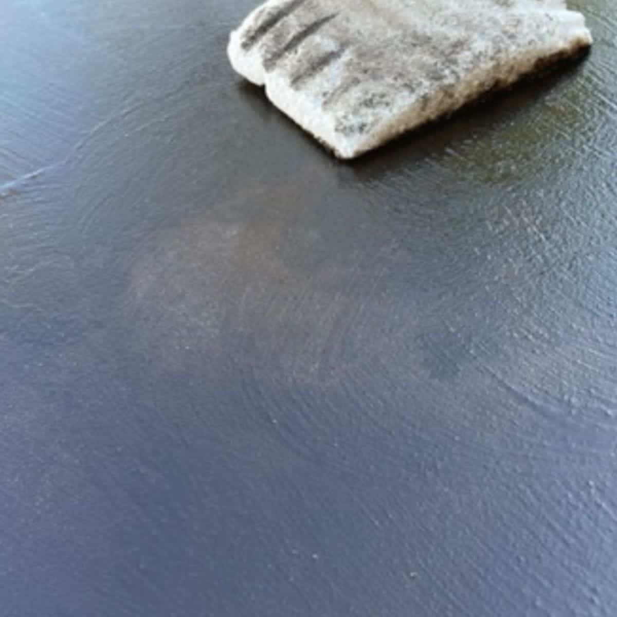 Blackstone griddle flaking being repaired using oil and a grill brick