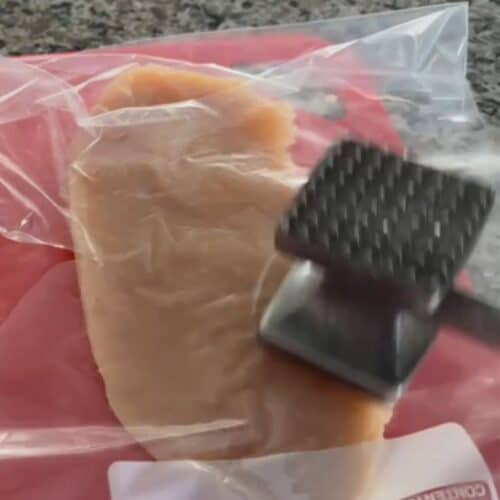Demonstrating how to flatten chicken breast using a ziplock bag and a meat tenderizer