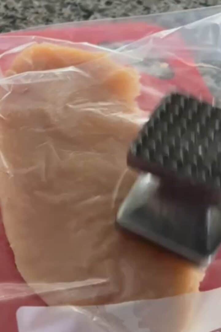 Demonstrating how to flatten chicken breast using a ziplock bag and a meat tenderizer