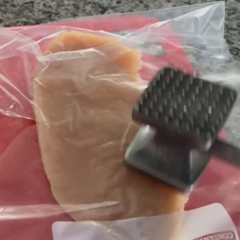 Demonstrating how to flatten chicken breast using a ziplock bag and a meat tenderizer