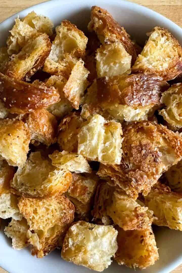 White bowl full of homemade croissant croutons