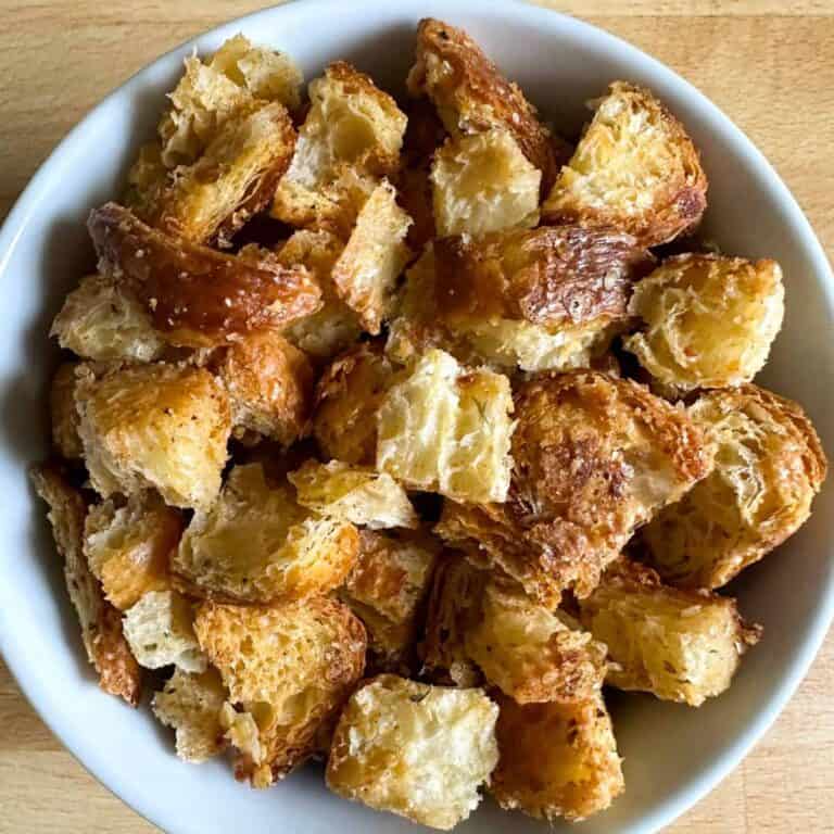 White bowl full of homemade croissant croutons