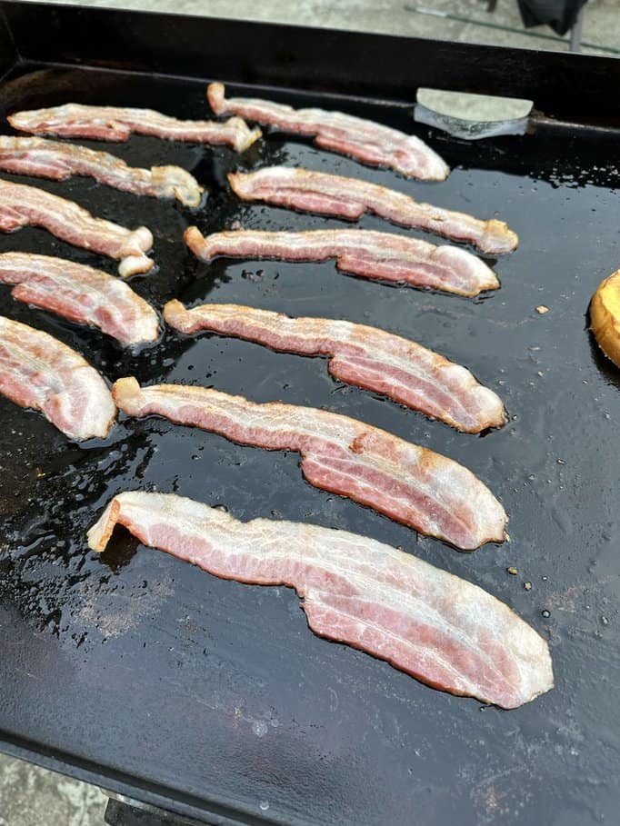 Bacon cooking on a Blackstone griddle