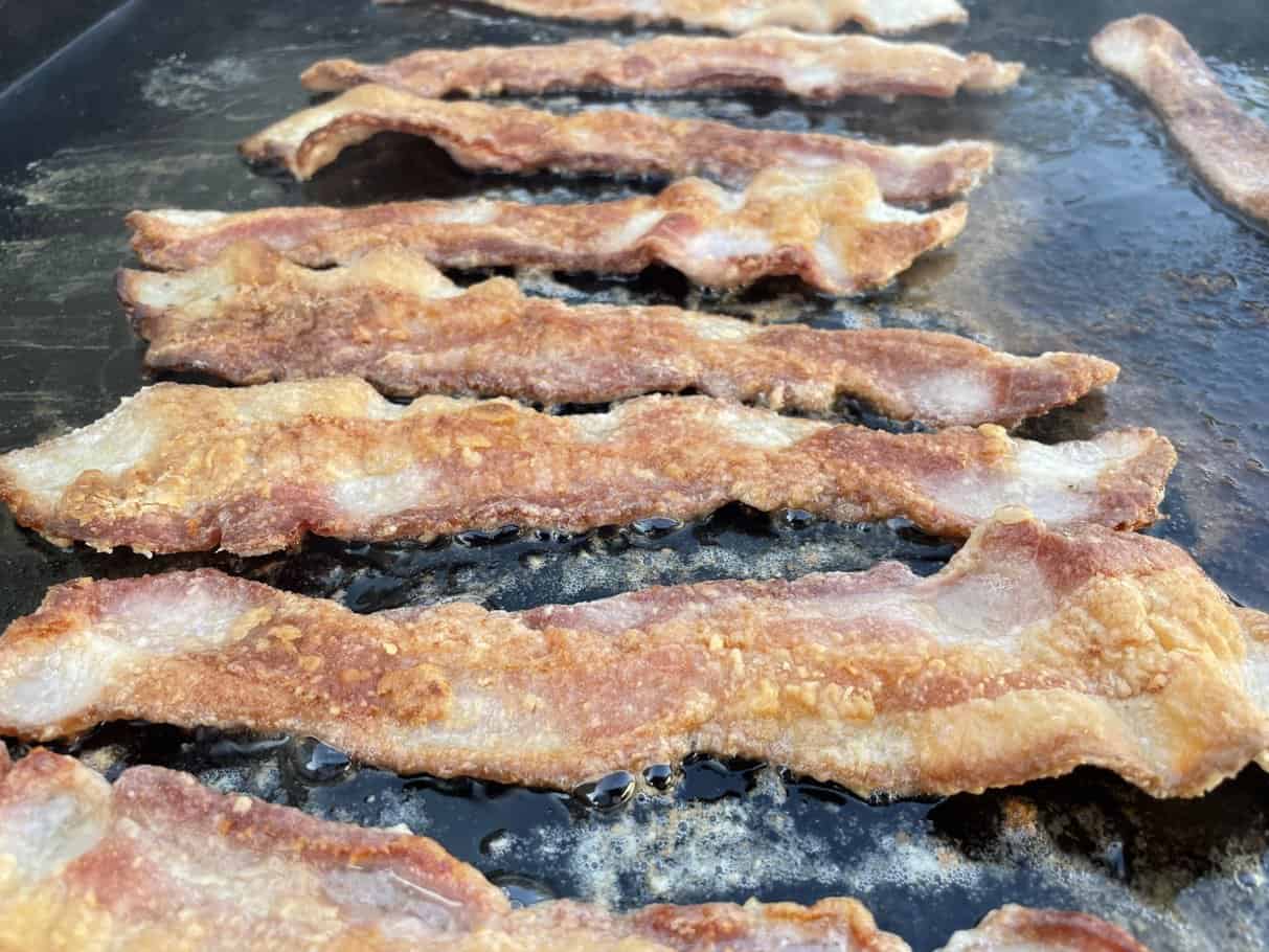 Bacon cooking on a Blackstone griddle