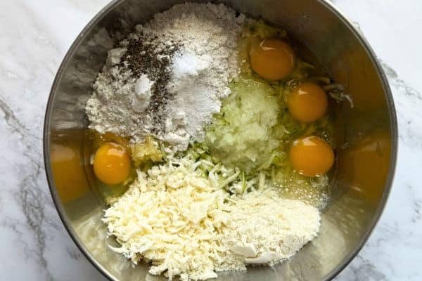 Ingredients for zucchinie pie in a mixing bowl