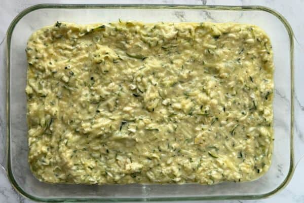 Zucchini pie in a baking dish about to go in the oven