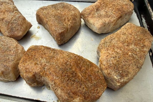 Pork chops on a baking sheet, finished sous vide and ready to be seared