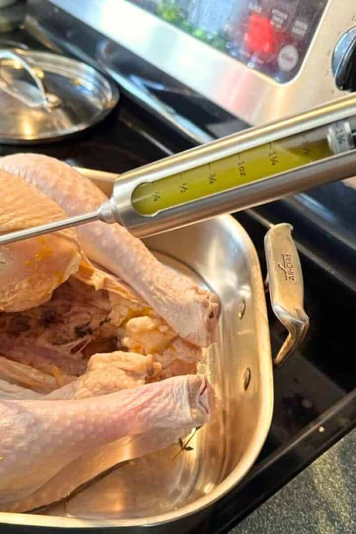Injecting a turkey with my recipe including butter, garlic, and herbs