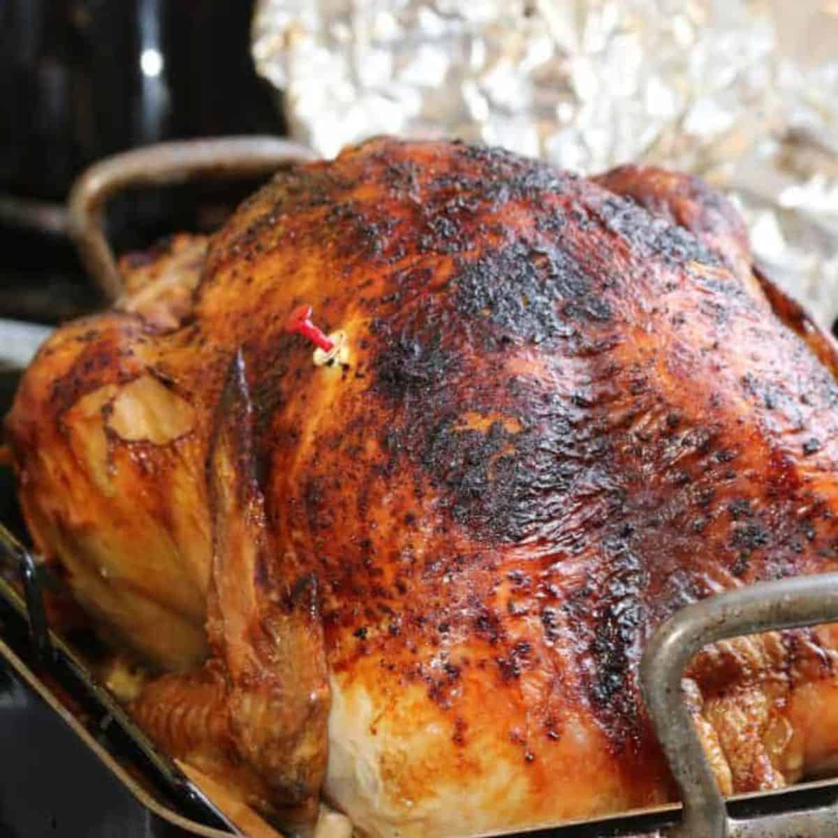 A cooked turkey with the pop up timer popped.