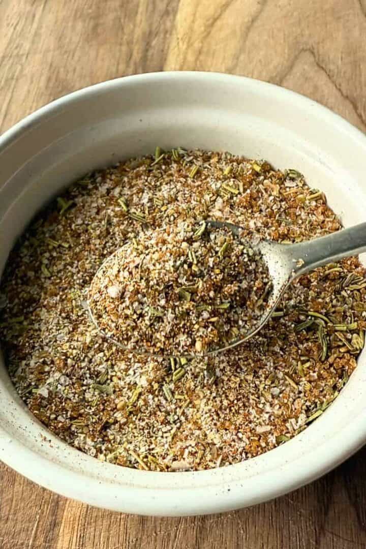 Turkey dry rub seasoning in a small white bowl with a silver spoon