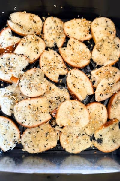 Seasoned bagel slices in an air fryer