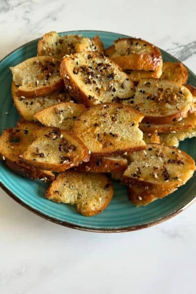 Blue plate full of homemade everything bagel chips