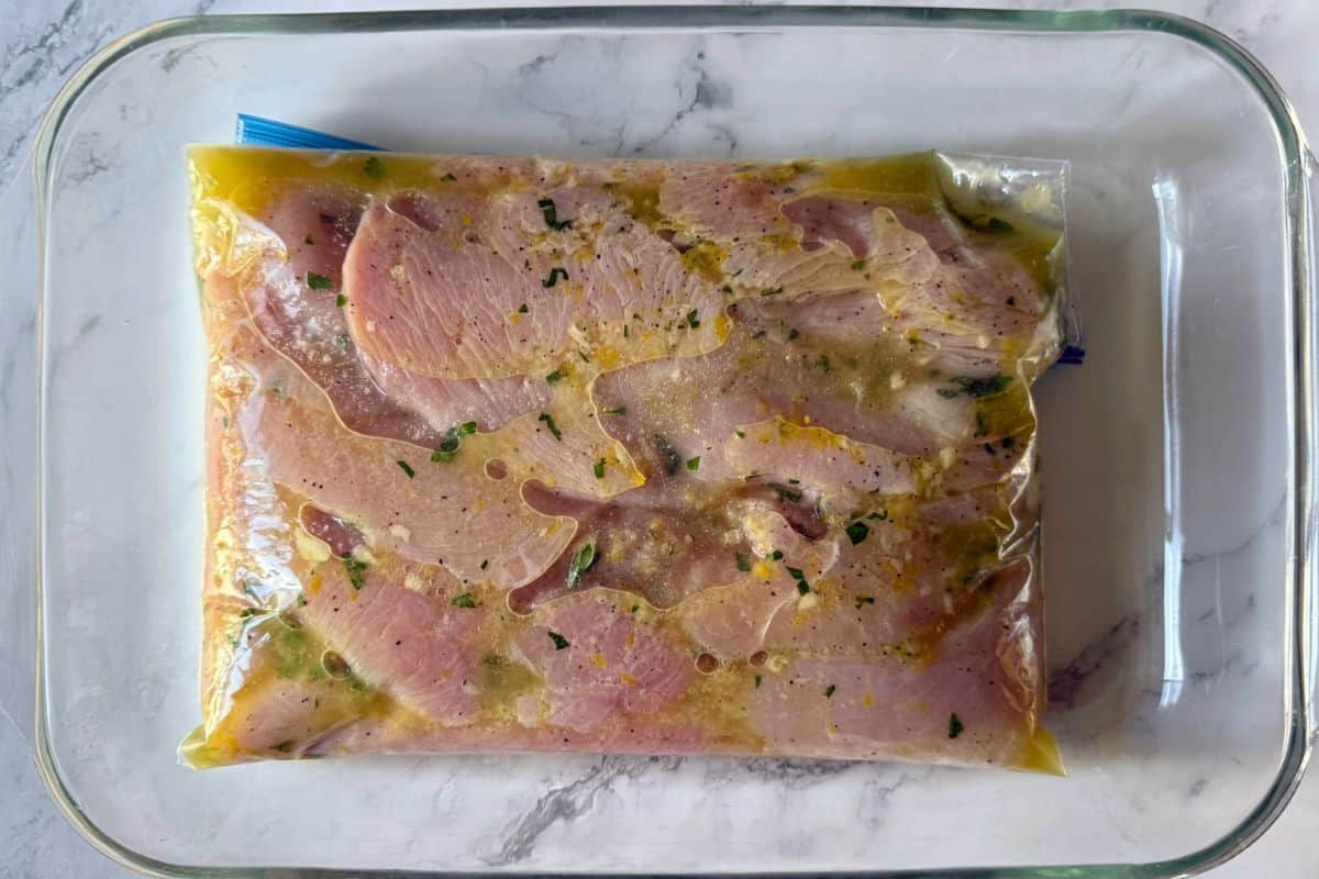 Chicken cutlets marinating in a sealable bag