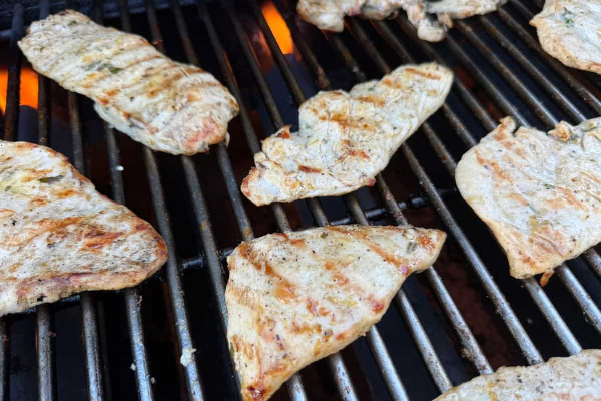 Marinted chicken breast cooking on a grill