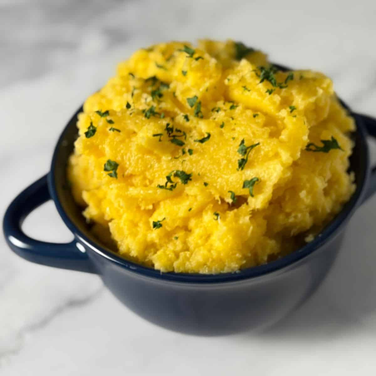 Blue bowl full of mashed rutagaba