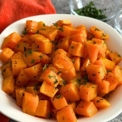 White bowl full of roasted butternut squash