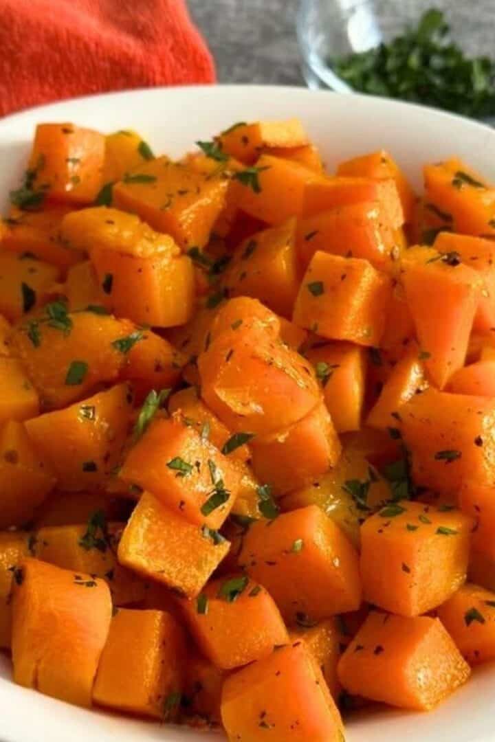 White bowl full of roasted butternut squash